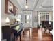 Elegant foyer featuring hardwood floors, decorative lighting, and a piano, leading into the dining area at 172 Sam Solomon Rd, Locust Grove, GA 30248