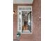 Open front door view to interiors with hardwood floors and modern light fixtures at 172 Sam Solomon Rd, Locust Grove, GA 30248