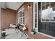 Cozy front porch features a bench, small table, and plants, creating an inviting outdoor space at 172 Sam Solomon Rd, Locust Grove, GA 30248