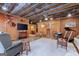 Spacious living room featuring rustic decor, exposed ceiling, and comfortable seating area at 172 Sam Solomon Rd, Locust Grove, GA 30248