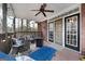 Relaxing covered patio with comfortable seating, ceiling fan, and access to the indoors through sliding glass doors at 172 Sam Solomon Rd, Locust Grove, GA 30248