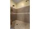 Walk-in shower with tiled walls, a shower head, and updated fixtures at 172 Sam Solomon Rd, Locust Grove, GA 30248