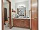 Bathroom with wooden cabinets, sink, mirror, and toilet room with shower at 439 Elder St, Fairburn, GA 30213