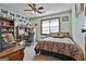 Cozy bedroom features a ceiling fan, a large window, desk and personal touches, creating an inviting space at 439 Elder St, Fairburn, GA 30213