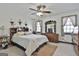 Bright bedroom features neutral colors, ceiling fan, and several windows with natural light at 439 Elder St, Fairburn, GA 30213