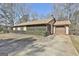 Ranch style home with a screened in porch, driveway, and partial view of the yard at 439 Elder St, Fairburn, GA 30213