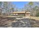 Ranch style home with a screened in porch, driveway, and partial view of the yard at 439 Elder St, Fairburn, GA 30213