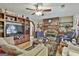 Spacious living room features a wood burning stone fireplace, wood look flooring, and ceiling fan at 439 Elder St, Fairburn, GA 30213