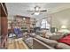 Spacious living room features a wood burning stone fireplace, wood look flooring, and natural lighting at 439 Elder St, Fairburn, GA 30213