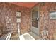 Inviting screened in porch, complete with wood shingle walls, decor and sitting bench at 439 Elder St, Fairburn, GA 30213