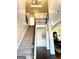 Bright foyer with high ceilings, hardwood floors, wrought iron banister, and decorative wall trim at 611 Winners Cir, Locust Grove, GA 30248