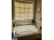 A relaxing soaking tub with a window view and stylish decor at 65 Coldwater Way, Covington, GA 30016