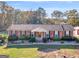 An elevated view of a brick single-story home with mature trees in the backyard and a well-kept lawn at 434 Lees Lake Rd, Fayetteville, GA 30214