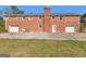 Backyard view of a two-story brick home with garages and an expansive lawn at 434 Lees Lake Rd, Fayetteville, GA 30214