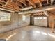 Unfinished basement with cement flooring, exposed ceiling, two windows, and a garage door entrance at 434 Lees Lake Rd, Fayetteville, GA 30214