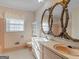 Retro bathroom featuring a double vanity, decorative mirrors and classic pink tile at 434 Lees Lake Rd, Fayetteville, GA 30214