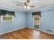 Cozy bedroom with hardwood floors and two sunny windows at 434 Lees Lake Rd, Fayetteville, GA 30214