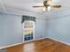 Bright bedroom with hardwood floors, ceiling fan, closet organizers and a sunlit window at 434 Lees Lake Rd, Fayetteville, GA 30214