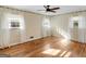 Comfortable bedroom with decorative wallpaper, ceiling fan, gleaming hardwood flooring and bright windows at 434 Lees Lake Rd, Fayetteville, GA 30214