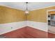 Inviting dining room featuring hardwood floors, textured wallpaper, and decorative light fixture at 434 Lees Lake Rd, Fayetteville, GA 30214