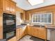 This kitchen features wood cabinets, a double oven, and a cooktop at 434 Lees Lake Rd, Fayetteville, GA 30214