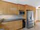 This kitchen includes wood cabinets, a stainless steel fridge, and ample counter space at 434 Lees Lake Rd, Fayetteville, GA 30214