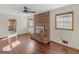 Bright living room boasts wood flooring, brick fireplace and access to kitchen at 434 Lees Lake Rd, Fayetteville, GA 30214