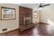 Spacious living room featuring a brick fireplace, wood floors, and natural light at 434 Lees Lake Rd, Fayetteville, GA 30214