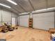 Interior of storage building with lawn equipment, shelving, and roll-up doors at 434 Lees Lake Rd, Fayetteville, GA 30214