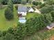 Aerial view of home featuring a pool, deck, two-car garage and private yard at 2110 Mcgarity Rd, Mcdonough, GA 30252