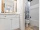 Bathroom featuring rustic mirror, white vanity, and tub with shower at 2110 Mcgarity Rd, Mcdonough, GA 30252