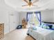 Bright bedroom featuring a large window with blue curtains, beanbag chair, and shelves at 2110 Mcgarity Rd, Mcdonough, GA 30252