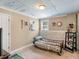 Bedroom features a window, exposed ceiling, and accent brick trim at 2110 Mcgarity Rd, Mcdonough, GA 30252