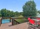 Deck with view of backyard pool and wooded area, including table and chairs at 2110 Mcgarity Rd, Mcdonough, GA 30252