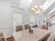 Bright dining room with a marble table, a large window, a skylight and an elegant chandelier at 2110 Mcgarity Rd, Mcdonough, GA 30252