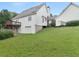 Rear exterior view of home featuring a deck, walkout basement and a manicured lawn at 2110 Mcgarity Rd, Mcdonough, GA 30252