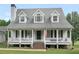 Beautiful two-story home with dormer windows and a classic front porch at 2110 Mcgarity Rd, Mcdonough, GA 30252