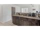 Open kitchen layout with dark wood cabinets, granite countertops, and ample workspace at 2110 Mcgarity Rd, Mcdonough, GA 30252