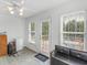 Sunlit room features neutral tile flooring, a mini fridge, and access to the backyard at 2110 Mcgarity Rd, Mcdonough, GA 30252