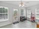 Cozy sun room with ceiling fan, three windows and an outside door leading to a deck and pool at 2110 Mcgarity Rd, Mcdonough, GA 30252