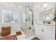 Luxurious marble bathroom with glass shower enclosure, white vanity, a large mirror, and stylish decor at 2405 Hillside Ave, Decatur, GA 30032