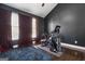 Home gym with exercise equipment, dark walls, hardwood floors, and lots of natural light at 2405 Hillside Ave, Decatur, GA 30032