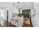 Bright eat-in kitchen with white cabinetry, marble countertops, a black accent wall, and stainless steel appliances at 2405 Hillside Ave, Decatur, GA 30032