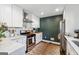 Galley kitchen featuring marble counters and backsplash, white cabinets, stainless steel appliances, and a tiger print rug at 2405 Hillside Ave, Decatur, GA 30032