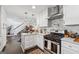 Stylish white kitchen with marble countertops, stainless steel appliances, and an open view of the living space at 2405 Hillside Ave, Decatur, GA 30032