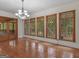 Elegant dining room with hardwood floors, chandelier lighting, and scenic backyard views at 95 Fern Ct, Stockbridge, GA 30281