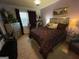 A bedroom with a large bed, stylish decor and plenty of natural light at 1687 Blue Heron Way, Hampton, GA 30228