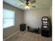 Bedroom area with a ceiling fan, window with blinds, and game machine at 1687 Blue Heron Way, Hampton, GA 30228