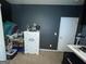 Bedroom features a white dresser and a dark gray painted wall at 1687 Blue Heron Way, Hampton, GA 30228