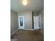Cozy bedroom with neutral walls and carpet, featuring closet and entry doors at 1687 Blue Heron Way, Hampton, GA 30228